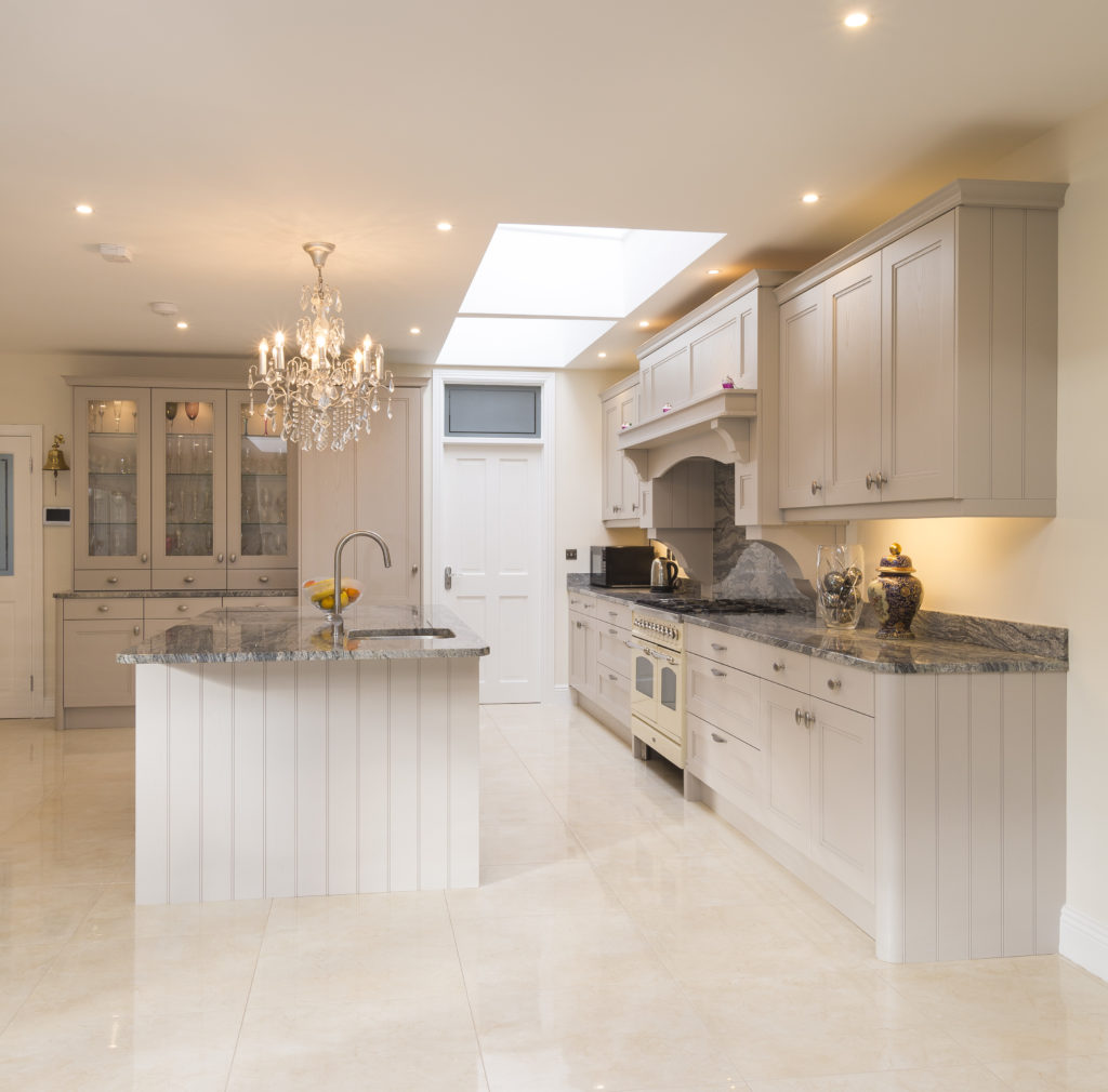 A kitchen with a tonal colour scheme, showing different elements painted in various shades of cream and greys. 