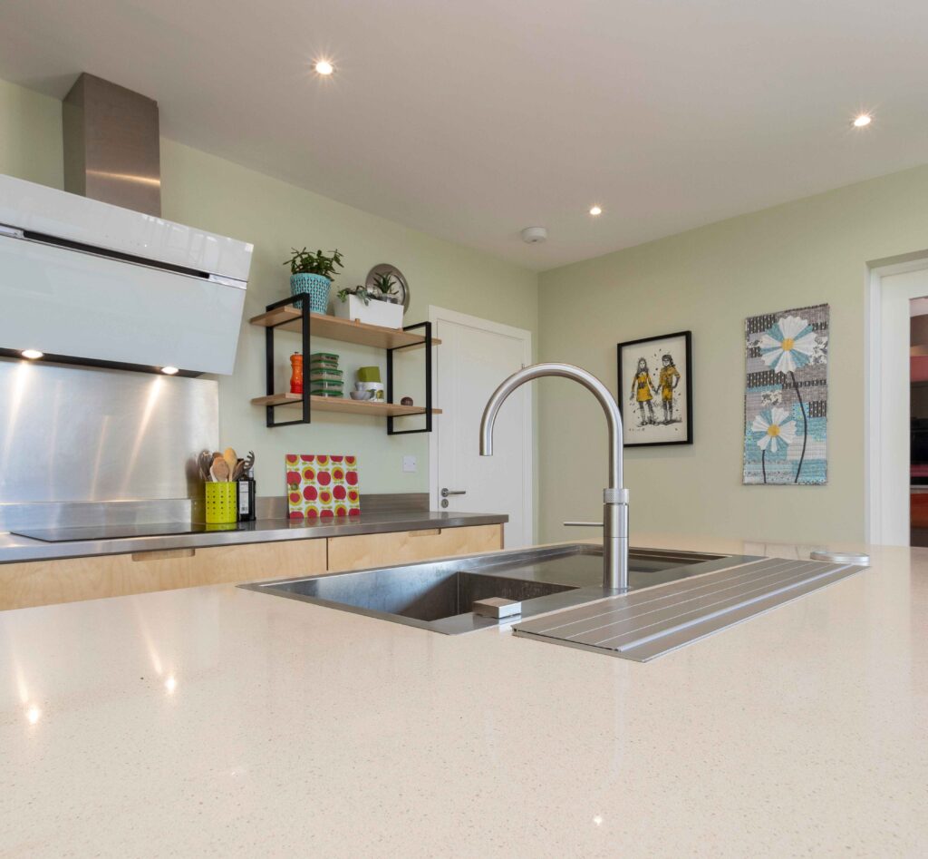 a brushed steel boiler tap complements a birch plywood kitchen